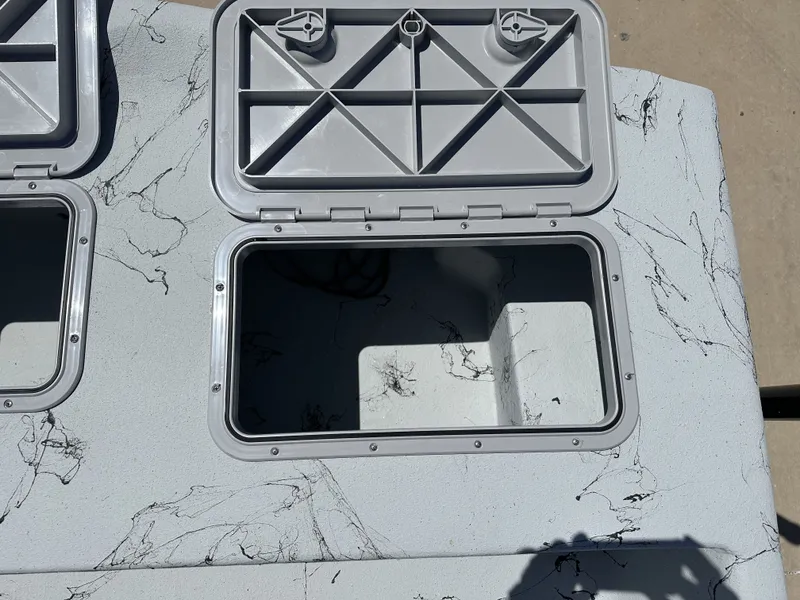 Slide: The Image of Open storage compartments on a 2026 Shoalwater 20' Catamaran. - 20