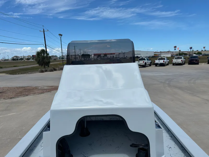 Slide: The Image of 2026 Shoalwater 23' Catamaran on parking lot under clear sky. - 23