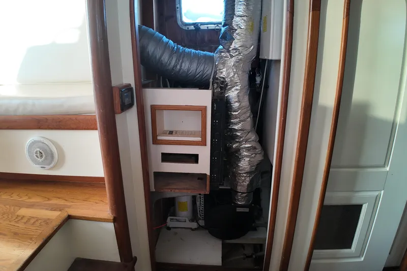 Slide: The Image of Interior of 1999 Anderson Downeast Aluminum Fast Trawler showing mechanical components and wooden accents. - 18