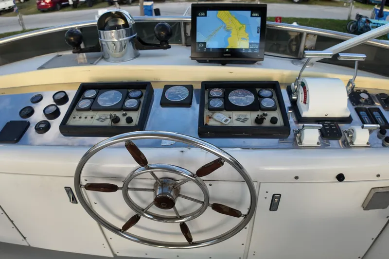 Slide: The Image of Helm of 1999 Anderson Downeast Aluminum Fast Trawler with navigation equipment and steering wheel. - 22