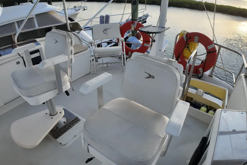 Slide: The Image of Deck of 1999 Anderson Downeast Aluminum Fast Trawler with seating and life rings. - 26