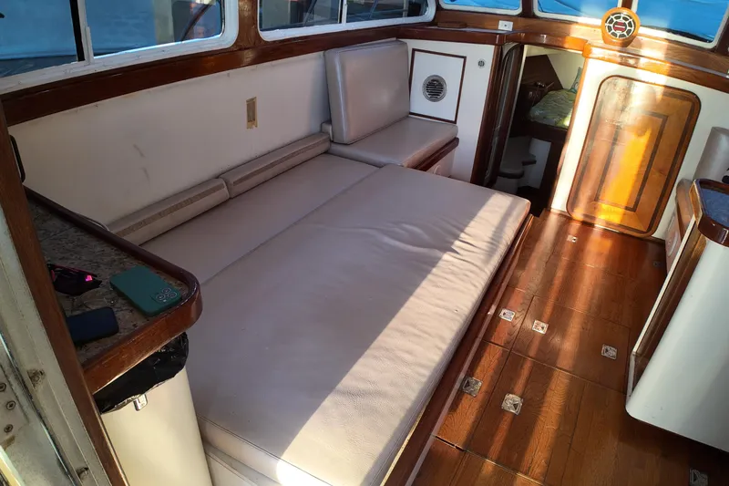 Slide: The Image of Interior of 1999 Anderson Downeast Aluminum Fast Trawler with wooden accents and cushioned seating. - 28