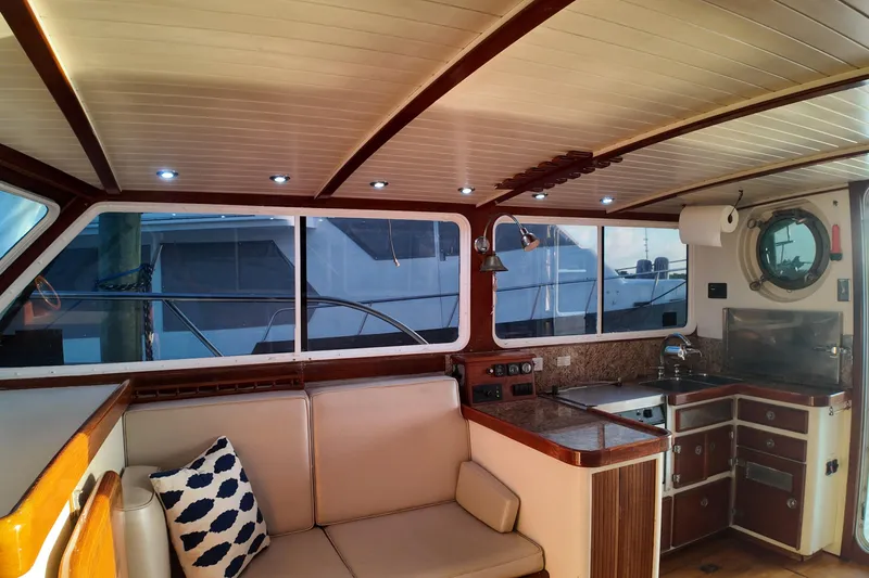 Slide: The Image of Interior of 1999 Anderson Downeast Aluminum Fast Trawler with cozy seating and kitchenette. - 31