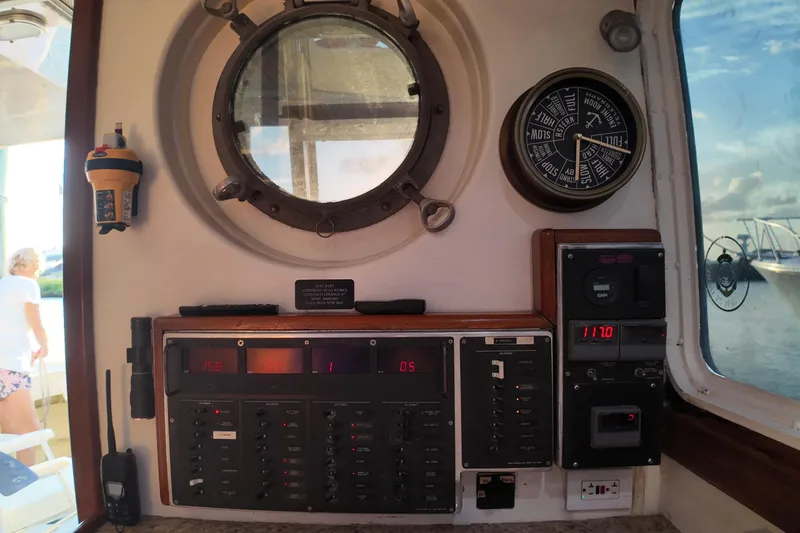 Slide: The Image of Interior view of 1999 Anderson Downeast Aluminum Fast Trawler control panel with gauges and porthole. - 32