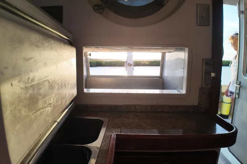 Slide: The Image of Interior view of 1999 Anderson Downeast Aluminum Fast Trawler kitchen with window and countertop. - 36
