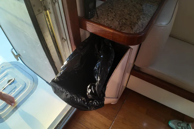 Slide: The Image of Interior of 1999 Anderson Downeast Trawler with trash bin and granite countertop. - 38