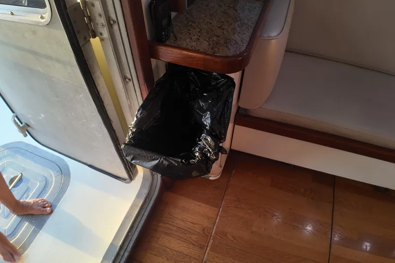 Slide: The Image of Interior of 1999 Anderson Downeast Trawler with trash bin and wooden flooring. - 40