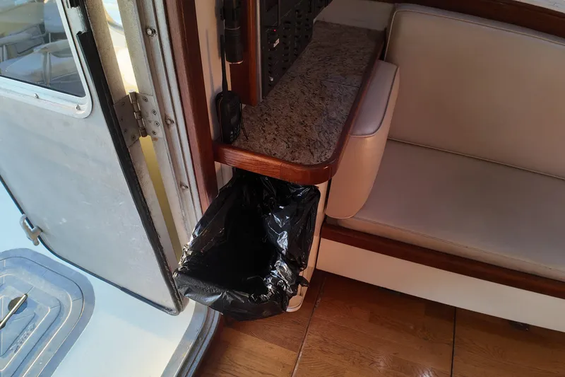 Slide: The Image of Interior of 1999 Anderson Downeast Trawler with granite counter and trash bin. - 41