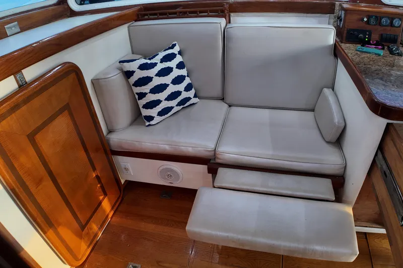 Slide: The Image of Cozy seating area on 1999 Anderson Downeast Aluminum Fast Trawler with nautical pillow. - 45