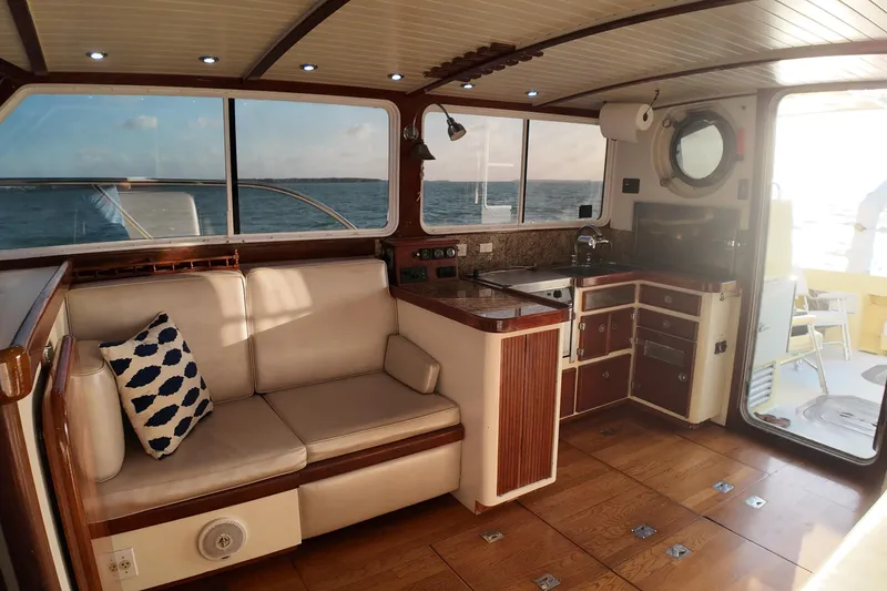 Slide: The Image of Interior of 1999 Anderson Downeast Aluminum Fast Trawler with cozy seating and kitchenette. - 8