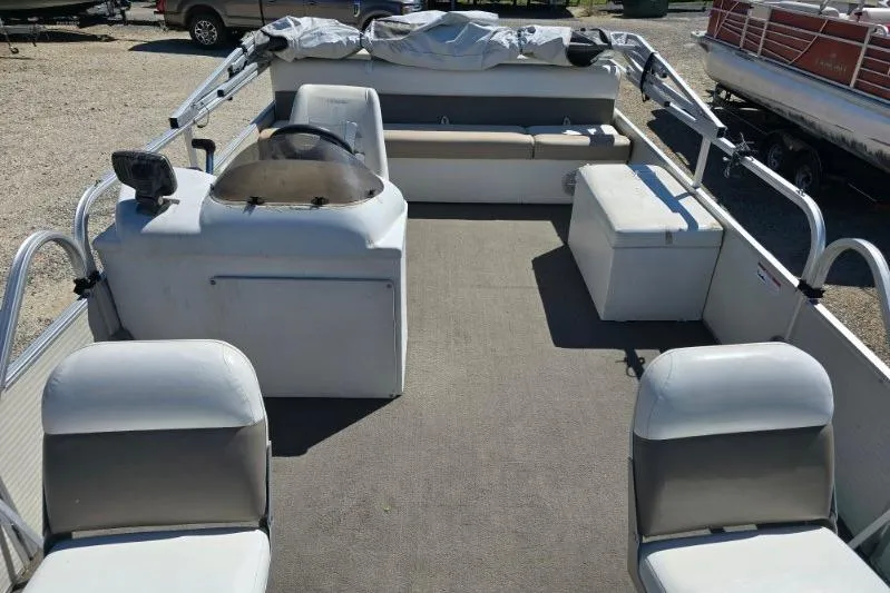 Slide: The Image of 2004 Bandit Pontoon boat interior with seating and steering console. - 4