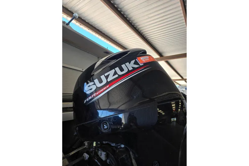 Slide: The Image of Suzuki four-stroke outboard motor on a 2004 Bandit Pontoon boat. - 8
