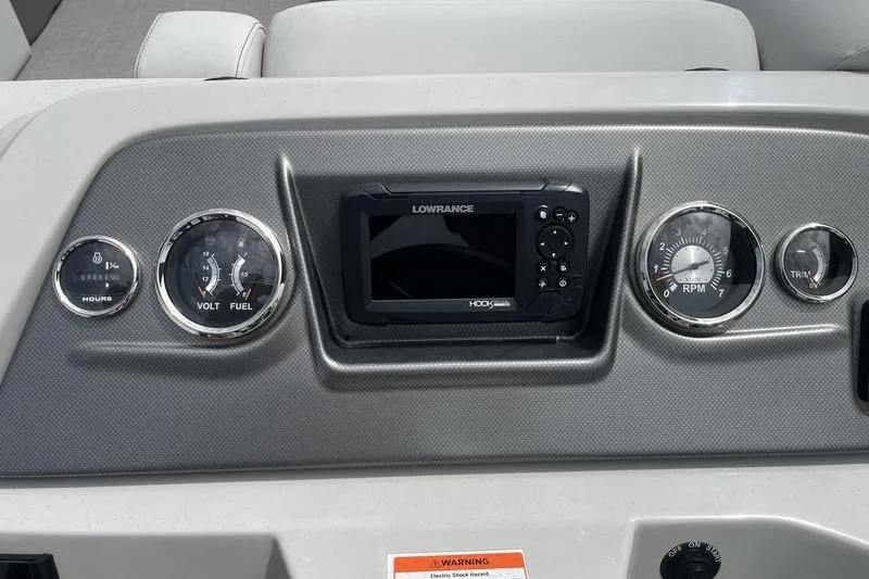 Slide: The Image of Dashboard of 2024 Crest Classic 220 boat with gauges and Lowrance display. - 10