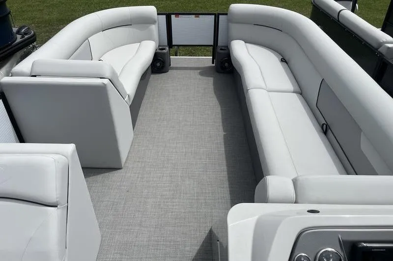 Slide: The Image of 2024 Crest Classic 220 pontoon boat interior with white seating and gray flooring. - 13