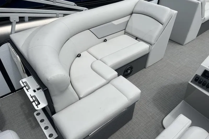 Slide: The Image of 2024 Crest Classic 220 boat interior with plush white seating and modern design. - 7