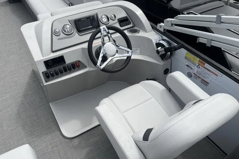 Slide: The Image of 2024 Crest Classic 220 boat helm with modern steering and controls. - 8