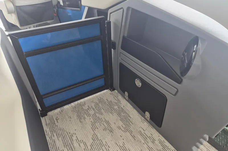 Slide: The Image of Interior view of 2026 Sylvan R-22 LZ DH boat, featuring storage compartments and seating. - 11