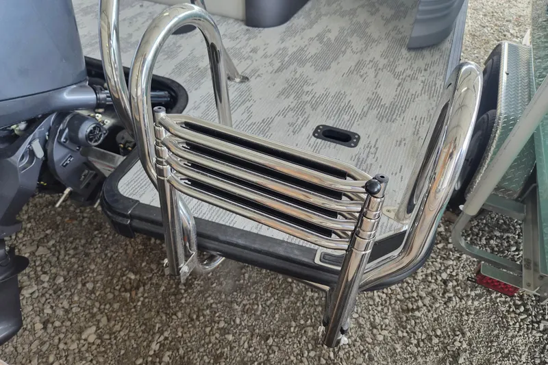 Slide: The Image of Chrome ladder on a 2026 Sylvan R-22 LZ DH boat, near engine and deck. - 15