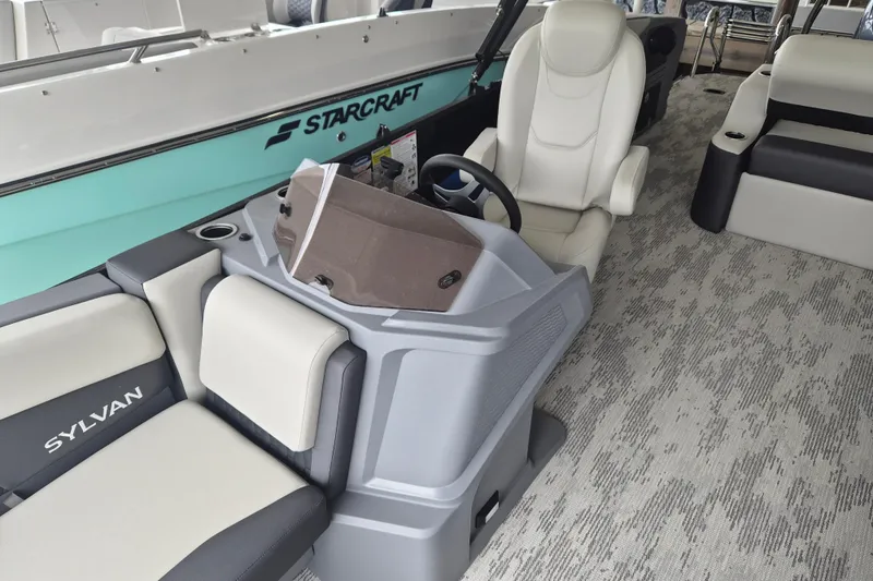 Slide: The Image of 2026 Sylvan R-22 LZ DH boat interior with steering console and seating. - 4