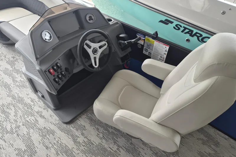 Slide: The Image of Captain's seat and helm of 2026 Sylvan R-22 LZ DH boat, featuring modern controls. - 7