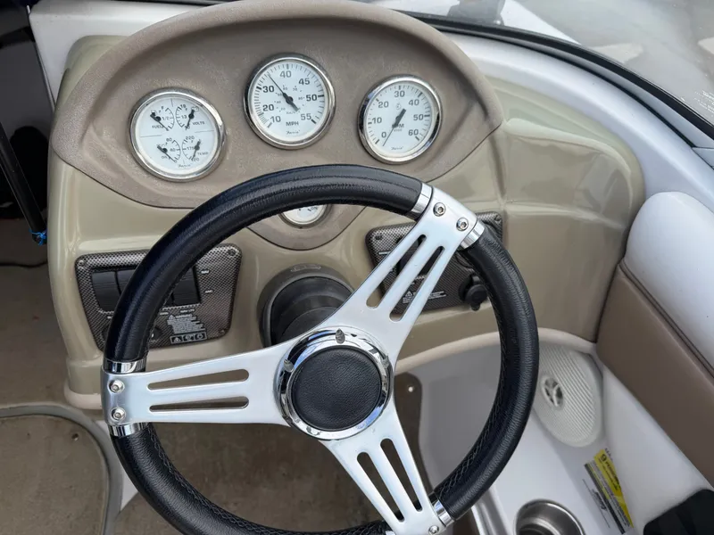 Slide: The Image of Steering wheel and dashboard of a 2010 Four Winns H190 F/S boat. - 13