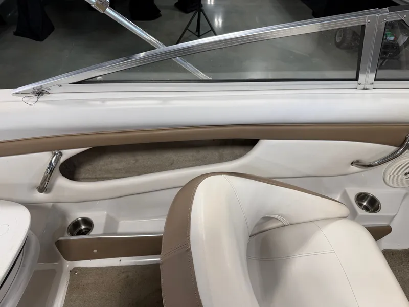 Slide: The Image of Interior of a 2010 Four Winns H190 F/S boat with beige and white upholstery. - 18