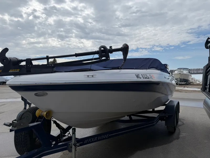 Slide: The Image of 2010 Four Winns H190 F/S boat on trailer under cloudy sky. - 2