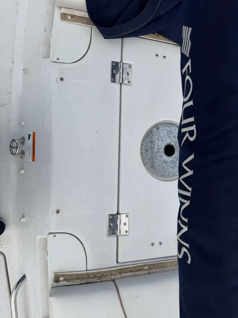 Slide: The Image of 2010 Four Winns H190 F/S boat deck with blue cover. - 25