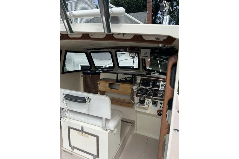Slide: The Image of 1998 General Marine Custom Downeast boat interior with steering wheel and control panel. - 10