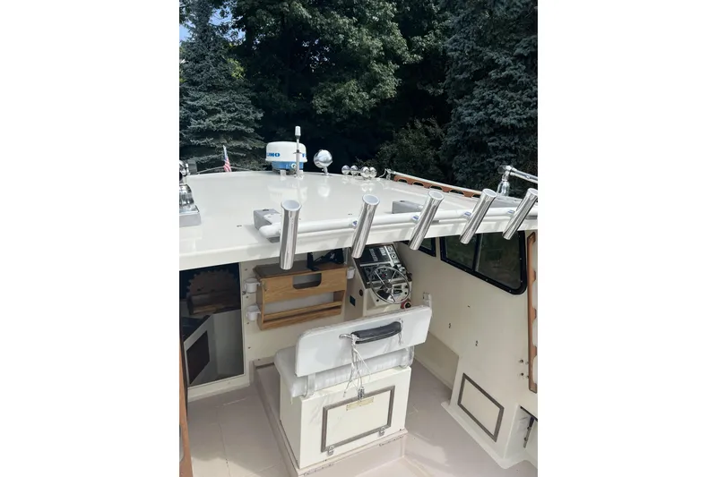 Slide: The Image of 1998 General Marine Custom Downeast boat interior with fishing rod holders and navigation equipment. - 12