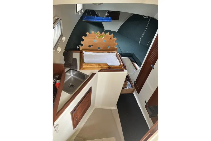 Slide: The Image of 1998 General Marine Custom Downeast boat interior with sink and wooden cabinetry. - 15