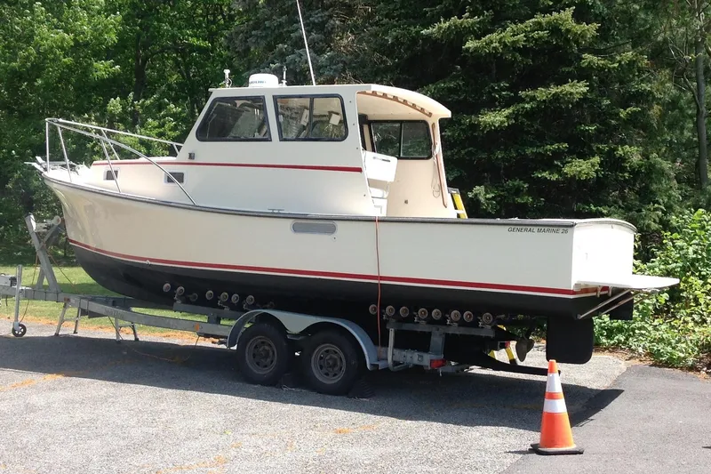 Slide: The Image of 1998 General Marine Custom Downeast boat on trailer, parked outdoors with trees in background. - 2