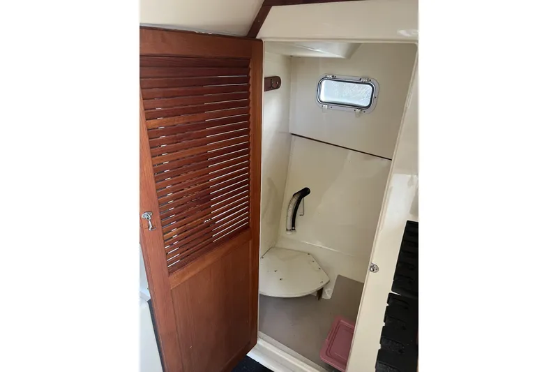 Slide: The Image of 1998 General Marine Custom Downeast boat interior with wooden door and small window. - 23