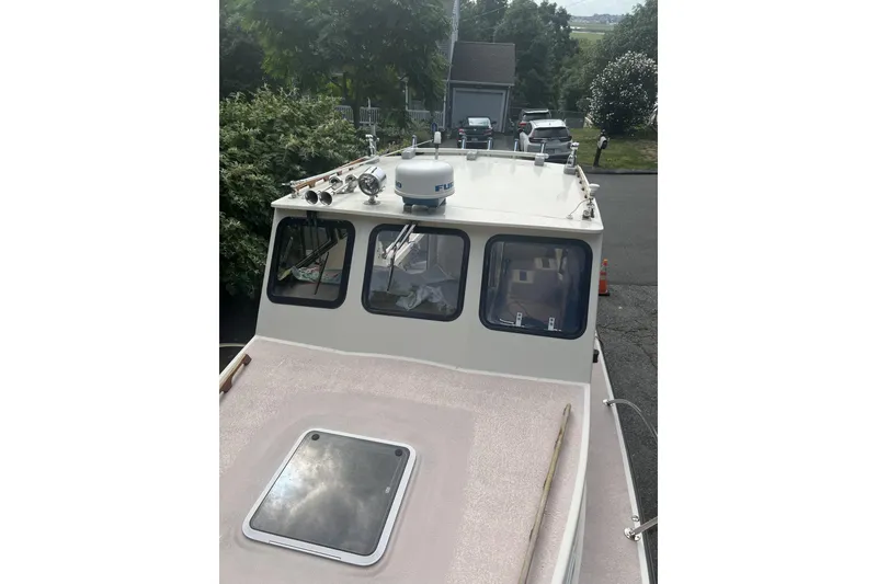 Slide: The Image of 1998 General Marine Custom Downeast boat with radar, docked in a driveway. - 6