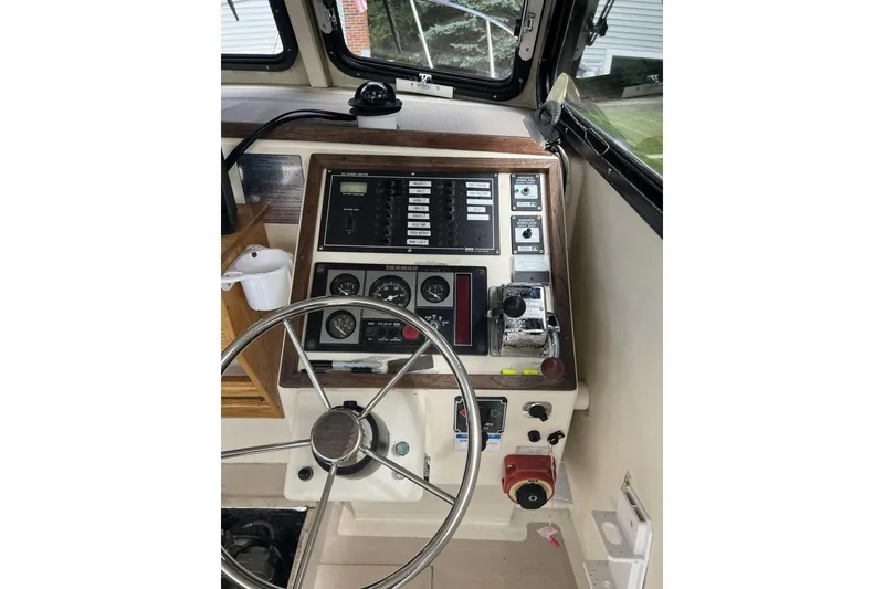 Slide: The Image of 1998 General Marine Custom Downeast boat helm with steering wheel and control panel. - 9