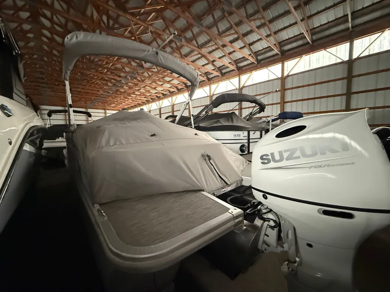 The Image of 2021 Bennington SSBXSD boat with Suzuki engine in storage facility. - 0