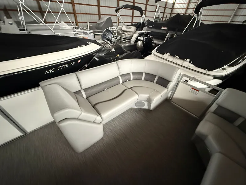Slide: The Image of Interior of a 2021 Bennington SSBXSD pontoon boat with gray seating. - 10