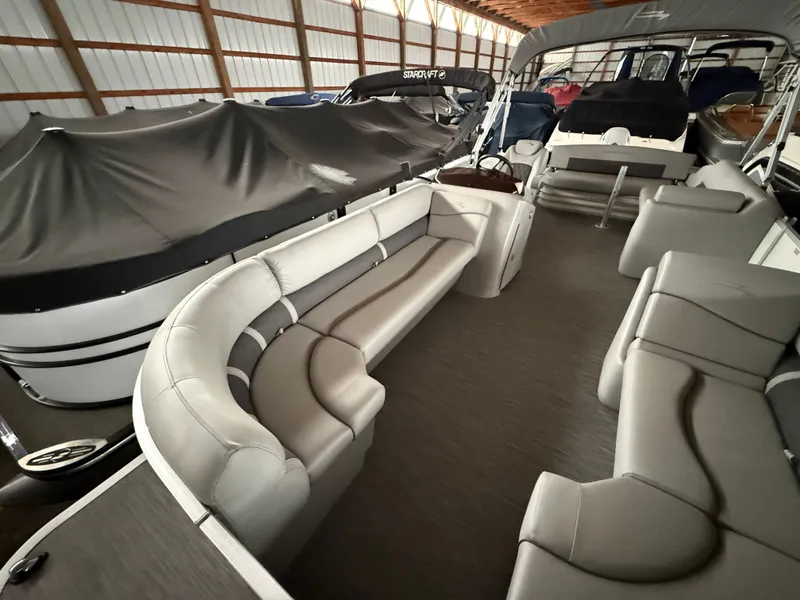 Slide: The Image of Interior of a 2021 Bennington SSBXSD pontoon boat in storage facility. - 11