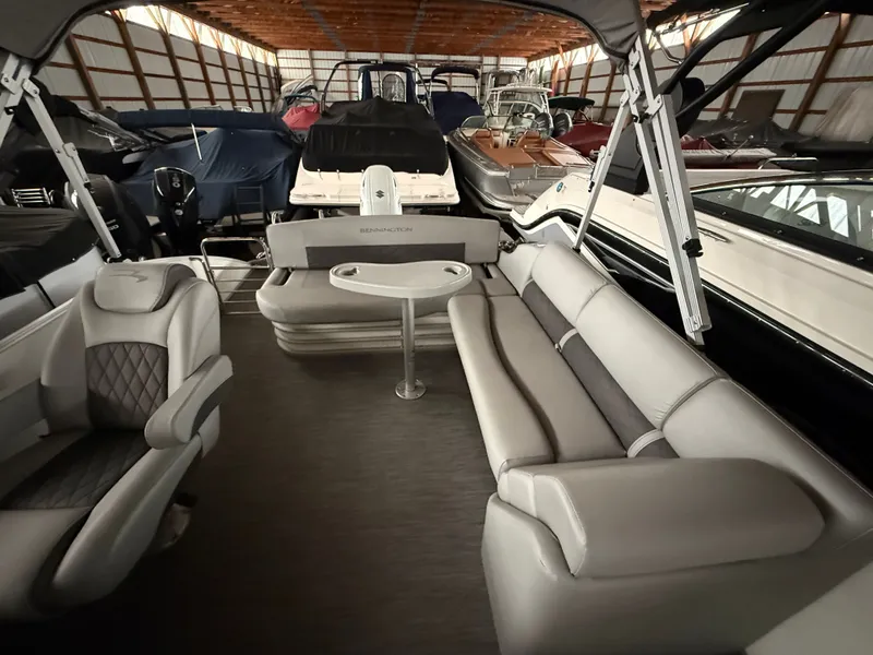 Slide: The Image of Interior of a 2021 Bennington SSBXSD pontoon boat in storage facility. - 13