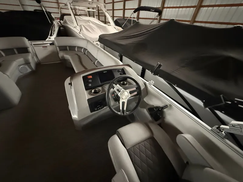 Slide: The Image of Interior view of a 2021 Bennington SSBXSD pontoon boat in storage. - 15