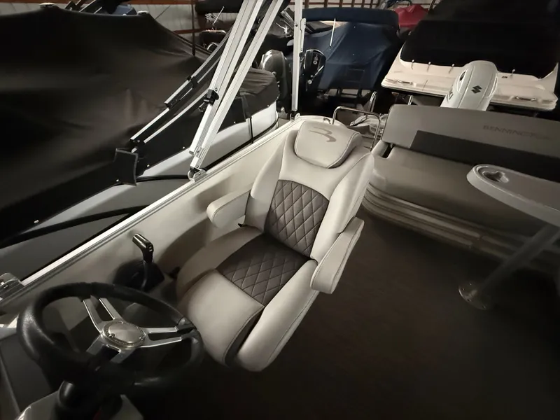 Slide: The Image of Interior of a 2021 Bennington SSBXSD boat with luxurious seating. - 16