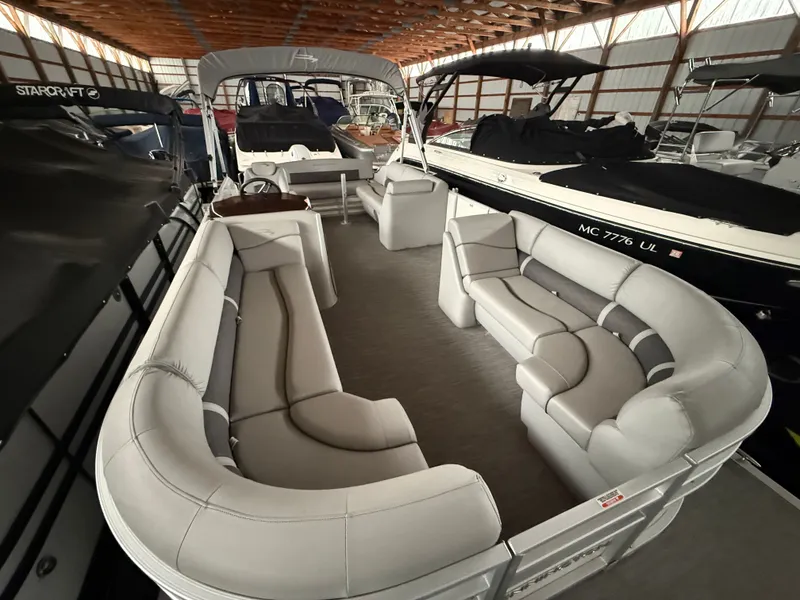 Slide: The Image of Interior view of a 2021 Bennington SSBXSD pontoon boat in storage. - 7