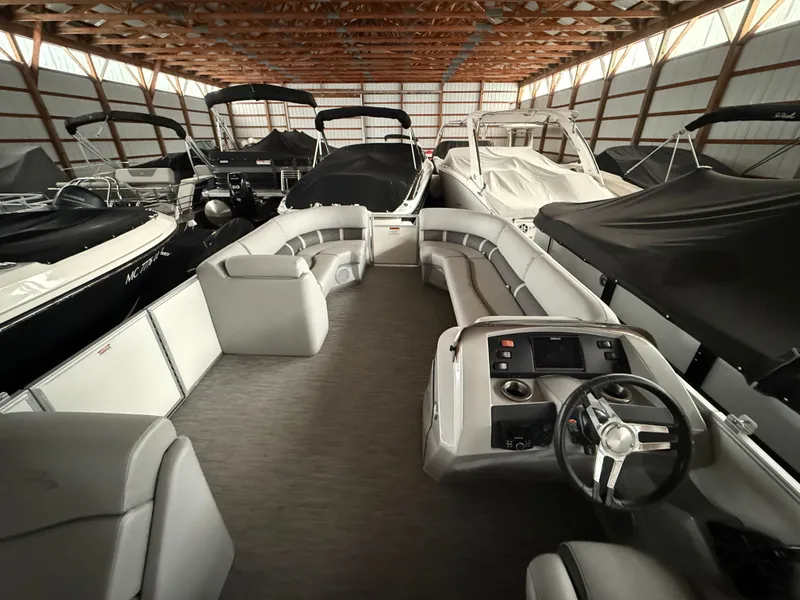 Slide: The Image of Interior view of a 2021 Bennington SSBXSD pontoon boat in storage facility. - 8