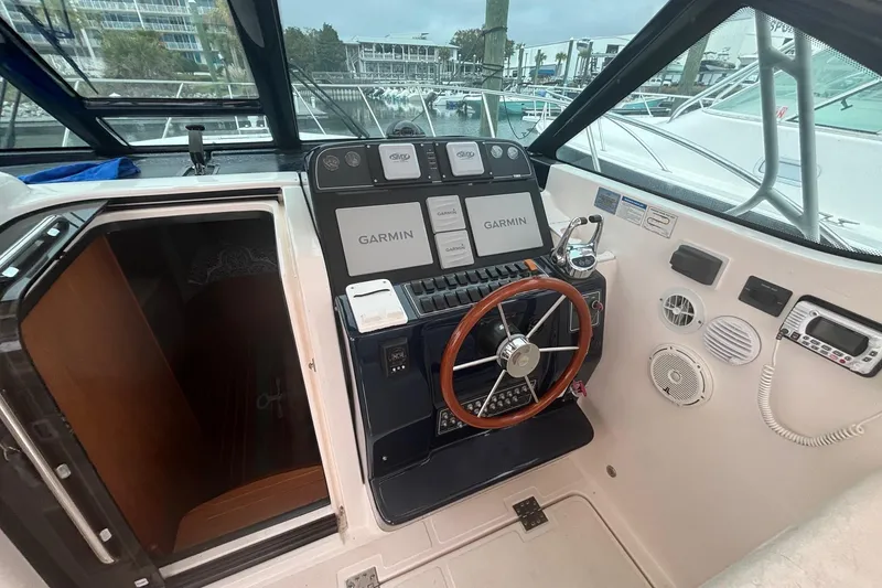 Slide: The Image of 2008 Tiara Yachts 3200 Open helm with Garmin navigation and wooden steering wheel. - 11
