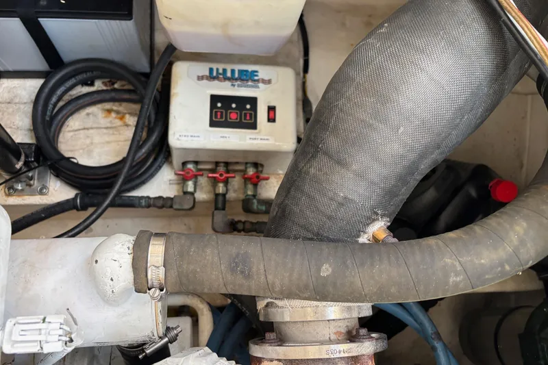 Slide: The Image of Engine compartment of a 2008 Tiara Yachts 3200 Open, featuring hoses and a U-Lube system. - 13