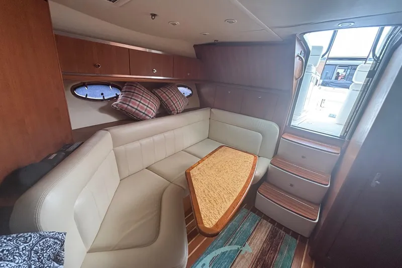 Slide: The Image of Interior of 2008 Tiara Yachts 3200 Open with cozy seating and wooden accents. - 14