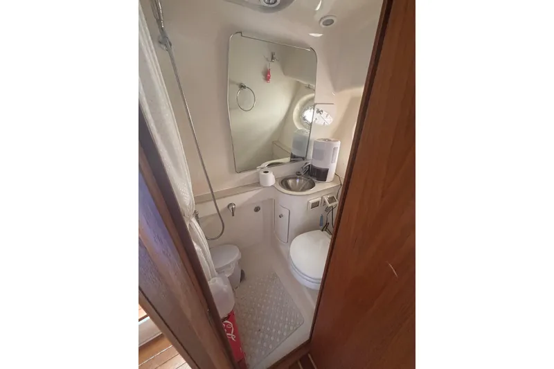 Slide: The Image of Compact bathroom in 2008 Tiara Yachts 3200 Open, featuring sink, toilet, and shower. - 15