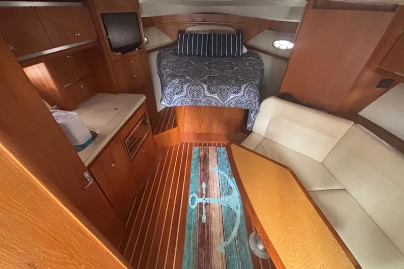 Slide: The Image of 2008 Tiara Yachts 3200 Open interior with bed, kitchenette, and seating area. - 17
