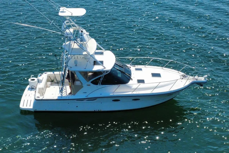 Slide: The Image of 2008 Tiara Yachts 3200 Open boat on sparkling blue water. - 2