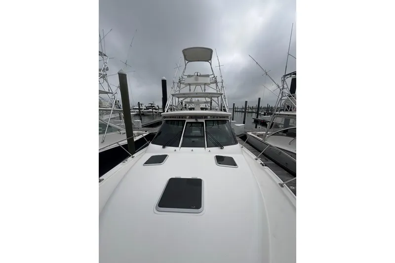 Slide: The Image of 2008 Tiara Yachts 3200 Open docked, showcasing sleek design and fishing tower. - 8